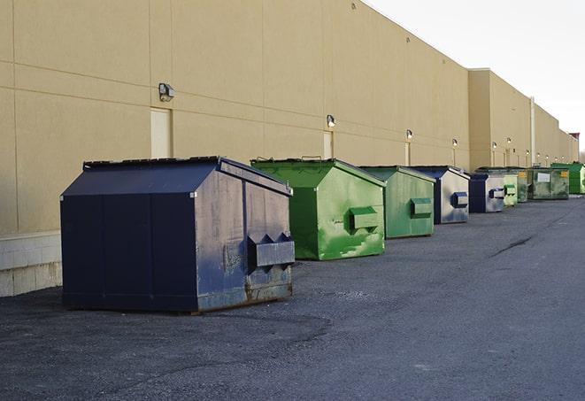 a group of construction workers taking a break near a dumpster in Bagdad